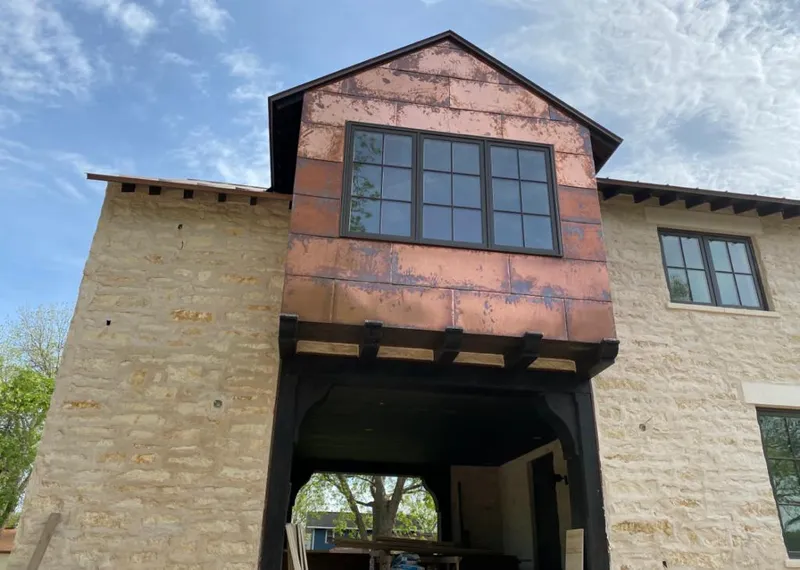 Copper metal panel facade on a stone building for Skylight Installation in Citrus